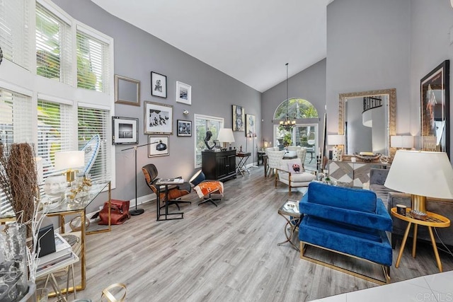 4520 Tarantella Ln, San Diego, CA 92130 - living area with high vaulted ceiling, wood finished floors, a chandelier, and baseboards