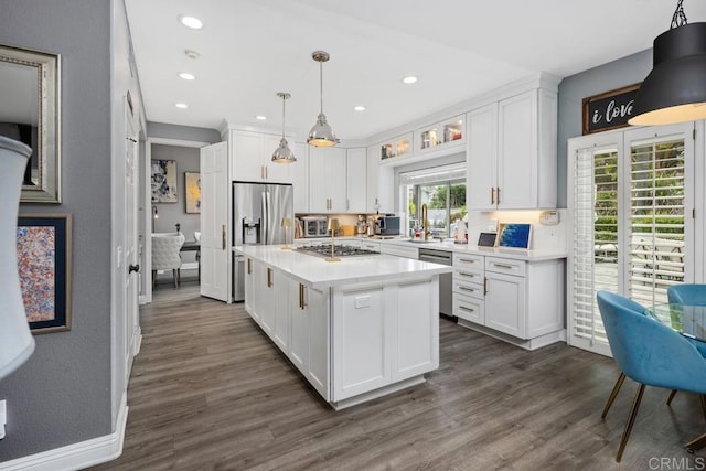 4520 Tarantella Ln, San Diego, CA 92130 - kitchen with white cabinets, light countertops, dark wood-style floors, stainless steel appliances, and recessed lighting