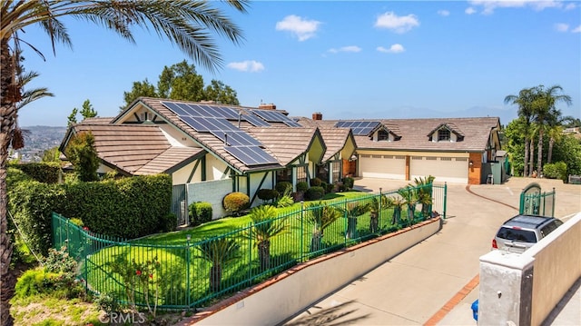 2360 Oakleaf Canyon Rd, Walnut, CA 91789 - english style home featuring roof mounted solar panels, driveway, and stucco siding