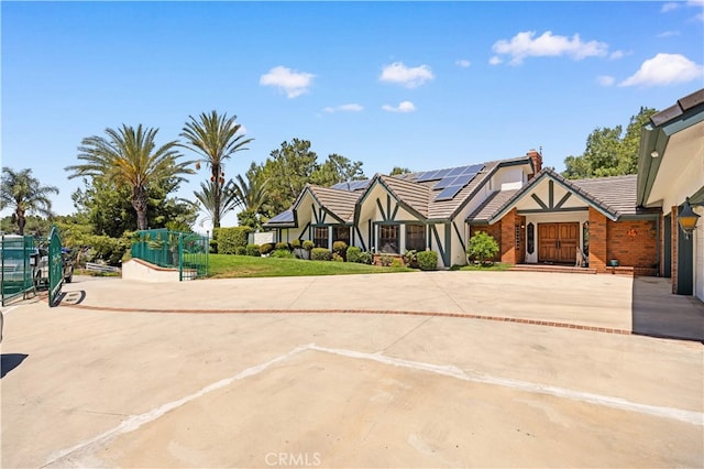 2360 Oakleaf Canyon Rd, Walnut, CA 91789 - view of front of property featuring solar panels, a tile roof, curved driveway, and brick siding