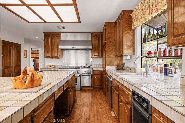 2360 Oakleaf Canyon Rd, Walnut, CA 91789 - kitchen featuring wall chimney exhaust hood, tile countertops, appliances with stainless steel finishes, a sink, and recessed lighting