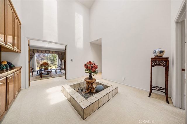 2360 Oakleaf Canyon Rd, Walnut, CA 91789 - living area featuring light carpet, a towering ceiling, and baseboards
