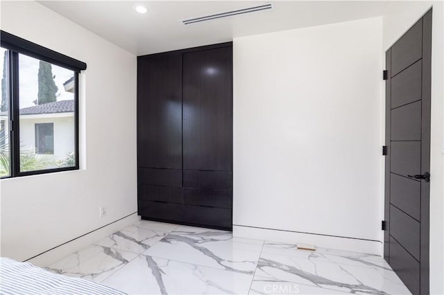 22940 Sherman Way, West Hills, CA 91307 - unfurnished bedroom with light marble finish flooring and recessed lighting