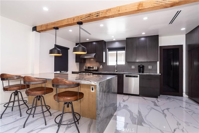 22940 Sherman Way, West Hills, CA 91307 - kitchen with appliances with stainless steel finishes, a kitchen bar, backsplash, light marble finish flooring, and modern cabinets