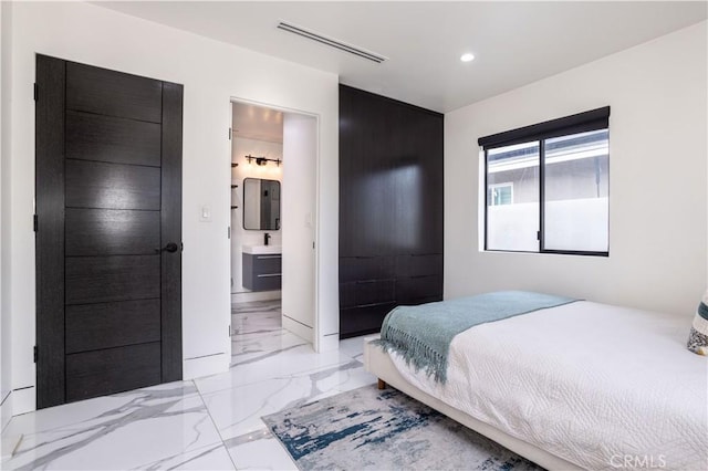 22940 Sherman Way, West Hills, CA 91307 - bedroom with light marble finish floors, recessed lighting, a sink, and ensuite bathroom