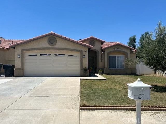 12248 Glenoaks Ln, Victorville, CA 92392 - mediterranean / spanish house with a tile roof, an attached garage, driveway, and stucco siding