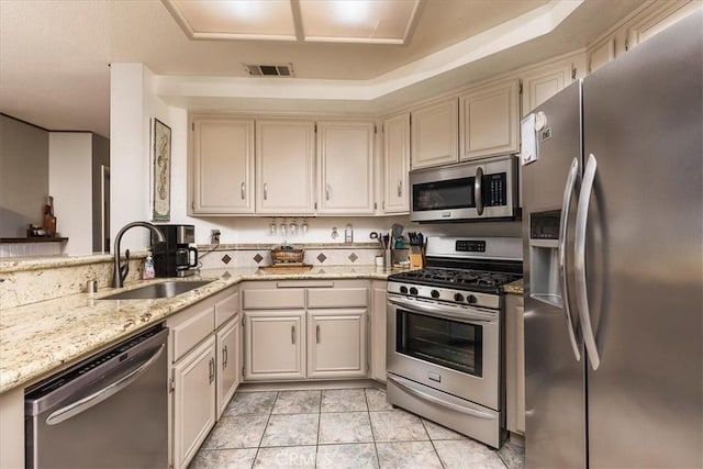 31488 Hallwood Ct, Menifee, CA 92584 - kitchen featuring stainless steel appliances, a sink, light stone countertops, and light tile patterned flooring
