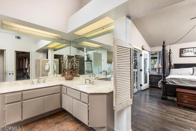 31488 Hallwood Ct, Menifee, CA 92584 - bathroom with double vanity, vaulted ceiling, and a spacious closet
