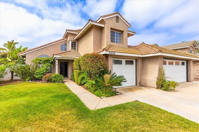 31488 Hallwood Ct, Menifee, CA 92584 - mediterranean / spanish-style home featuring stucco siding, concrete driveway, a tile roof, a front lawn, and a garage