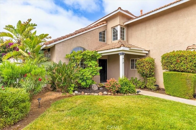 31488 Hallwood Ct, Menifee, CA 92584 - mediterranean / spanish home featuring a tile roof, a front yard, and stucco siding