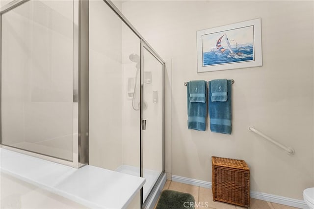 1574 Litchfield Ct, Banning, CA 92220 - bathroom featuring a stall shower, toilet, baseboards, and tile patterned floors