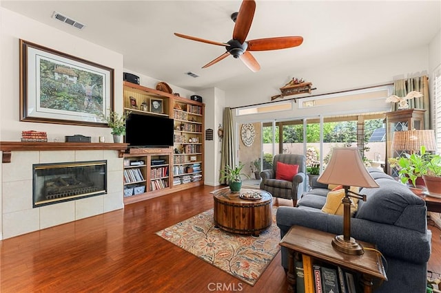 1574 Litchfield Ct, Banning, CA 92220 - living room featuring wood finished floors, ceiling fan, and a fireplace