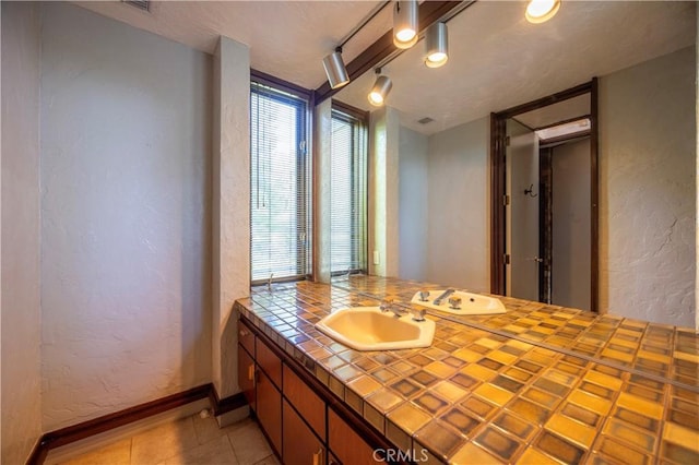 23615 Falcons View Dr, Diamond Bar, CA 91765 - bathroom with a textured wall, baseboards, vanity, and tile patterned flooring