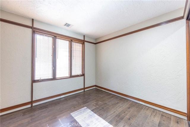 23615 Falcons View Dr, Diamond Bar, CA 91765 - empty room featuring wood finished floors, a textured wall, and baseboards