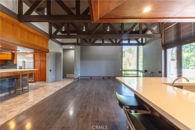 23615 Falcons View Dr, Diamond Bar, CA 91765 - kitchen featuring brown cabinetry, built in refrigerator, open floor plan, a kitchen breakfast bar, and dark wood-type flooring