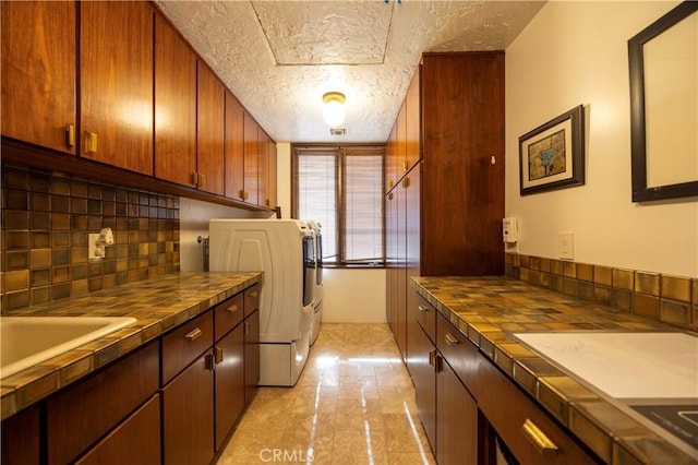 23615 Falcons View Dr, Diamond Bar, CA 91765 - laundry room featuring a textured ceiling, washing machine and clothes dryer, and cabinet space