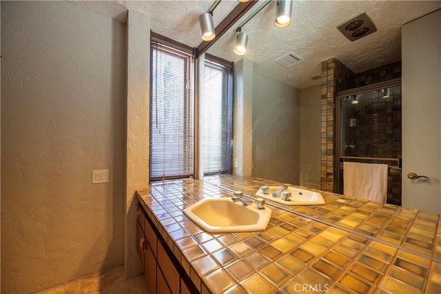 23615 Falcons View Dr, Diamond Bar, CA 91765 - full bathroom featuring a textured wall, a textured ceiling, vanity, and tiled shower