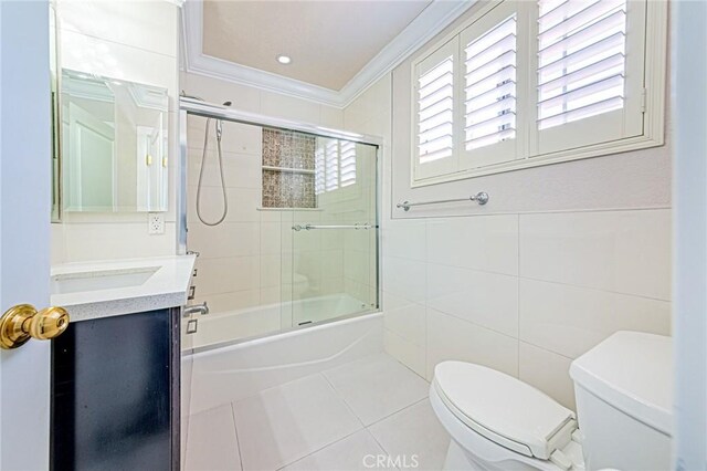 13184 Spire Cir, Chino Hills, CA 91709 - bathroom featuring toilet, tile walls, tile patterned floors, bath / shower combo with glass door, and ornamental molding