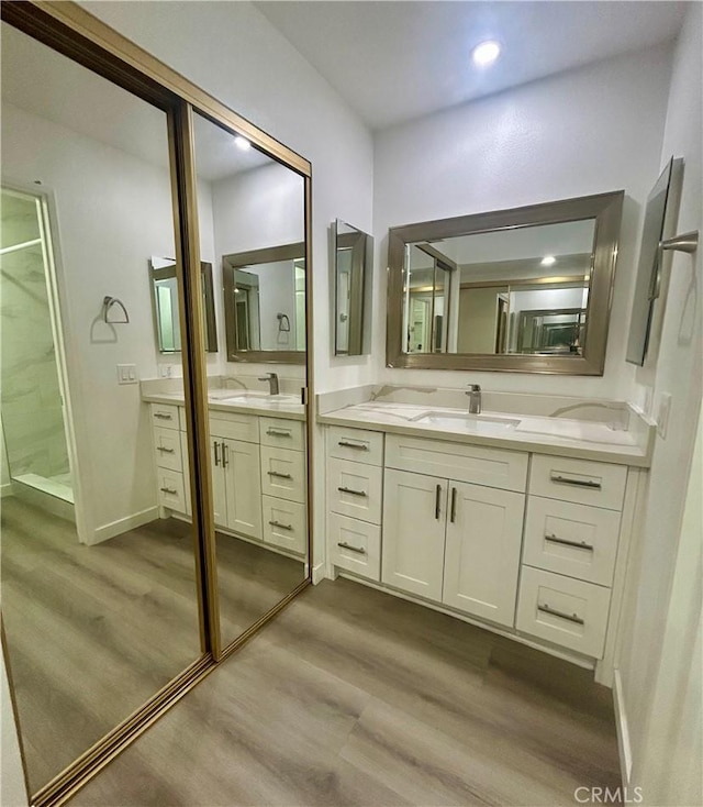 333 Burchett St Unit 203, Glendale, CA 91203 - bathroom featuring wood finished floors, two vanities, a shower, and recessed lighting