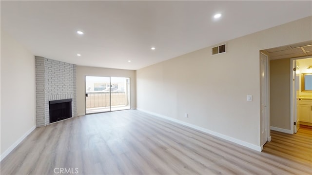 333 Burchett St Unit 203, Glendale, CA 91203 - unfurnished living room featuring light wood-style flooring, recessed lighting, and a brick fireplace