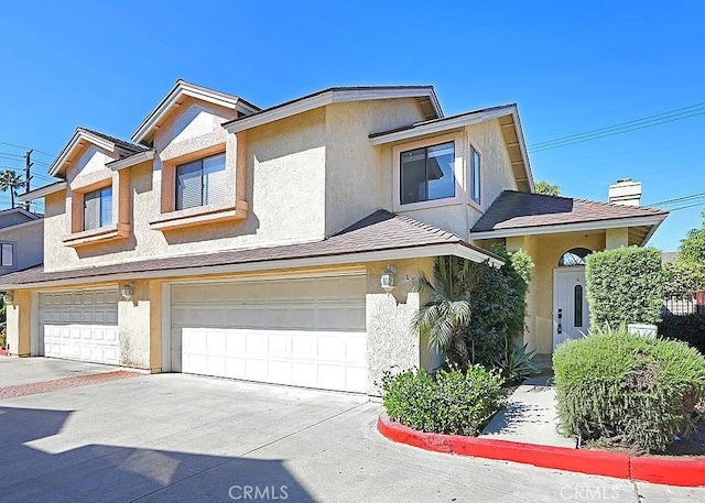 726 W Wilson St Unit K, Costa Mesa, CA 92627 - townhome / multi-family property featuring a garage, stucco siding, and concrete driveway