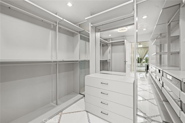 1046 N Hillcrest Rd, Beverly Hills, CA 90210 - walk in closet featuring light tile patterned flooring