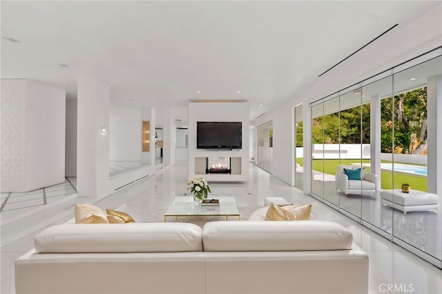 1046 N Hillcrest Rd, Beverly Hills, CA 90210 - tiled living room featuring healthy amount of natural light, a warm lit fireplace, and recessed lighting