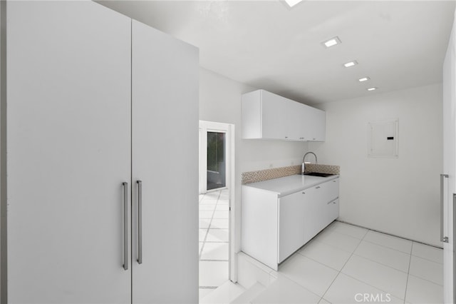 1046 N Hillcrest Rd, Beverly Hills, CA 90210 - kitchen with a sink, light countertops, white cabinetry, paneled fridge, and electric panel