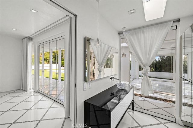 1046 N Hillcrest Rd, Beverly Hills, CA 90210 - sunroom featuring healthy amount of natural light and a skylight