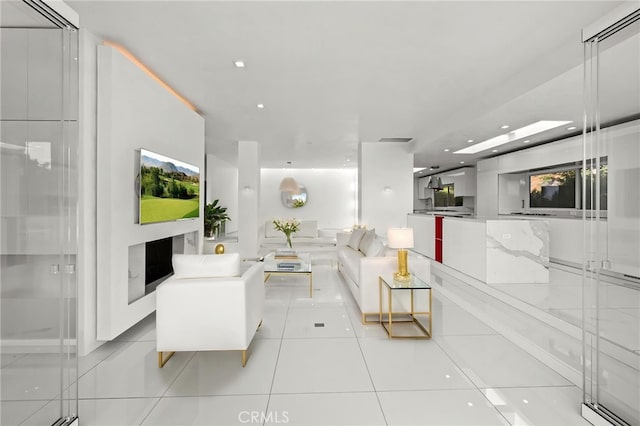 1046 N Hillcrest Rd, Beverly Hills, CA 90210 - tiled living room with a fireplace and recessed lighting