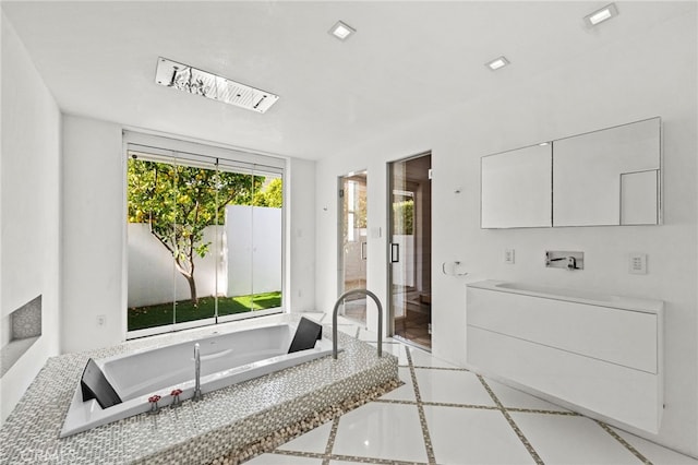 1046 N Hillcrest Rd, Beverly Hills, CA 90210 - bathroom with vanity, a bathtub, and inlaid floor details