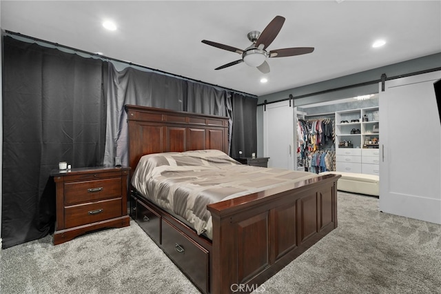 10113 Hemlock St, Rancho Cucamonga, CA 91730 - bedroom featuring a barn door, light colored carpet, a spacious closet, recessed lighting, and a closet