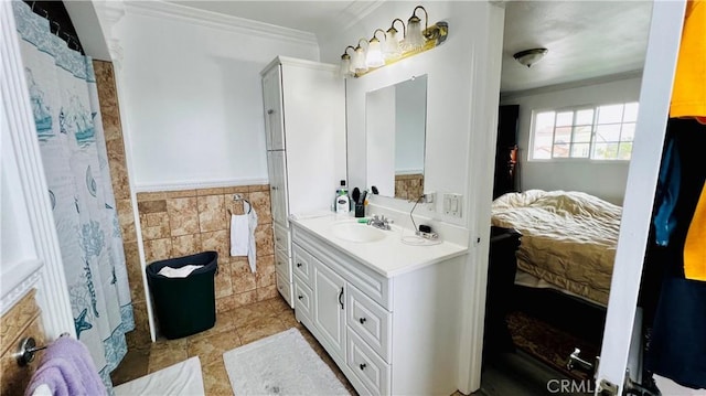 4127 W 130th St, Hawthorne, CA 90250 - bathroom with ornamental molding, vanity, tile walls, a wainscoted wall, and tile patterned floors