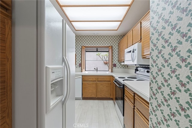 9 Edgestone, Irvine, CA 92606 - kitchen with white appliances, wallpapered walls, light countertops, a sink, and brown cabinetry