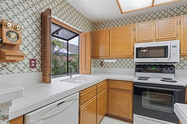 9 Edgestone, Irvine, CA 92606 - kitchen with wallpapered walls, white appliances, a sink, and light countertops