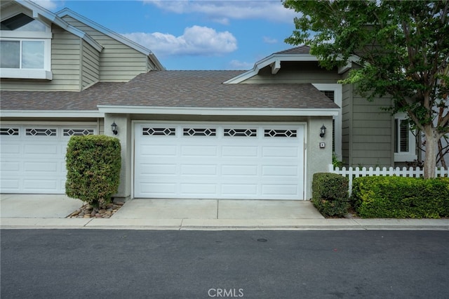 9 Edgestone, Irvine, CA 92606 - view of side of property with a shingled roof, driveway, and an attached garage