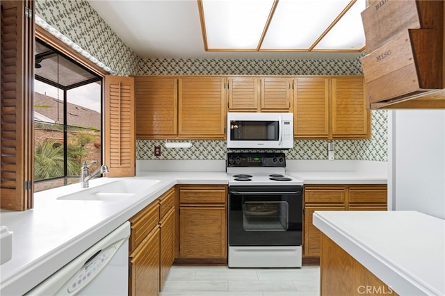 9 Edgestone, Irvine, CA 92606 - kitchen featuring white appliances, a sink, light countertops, wallpapered walls, and ventilation hood