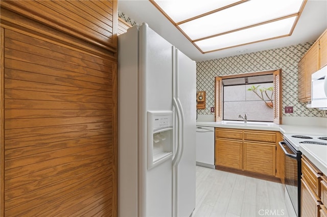 9 Edgestone, Irvine, CA 92606 - kitchen with white appliances, a sink, wallpapered walls, light countertops, and light wood finished floors