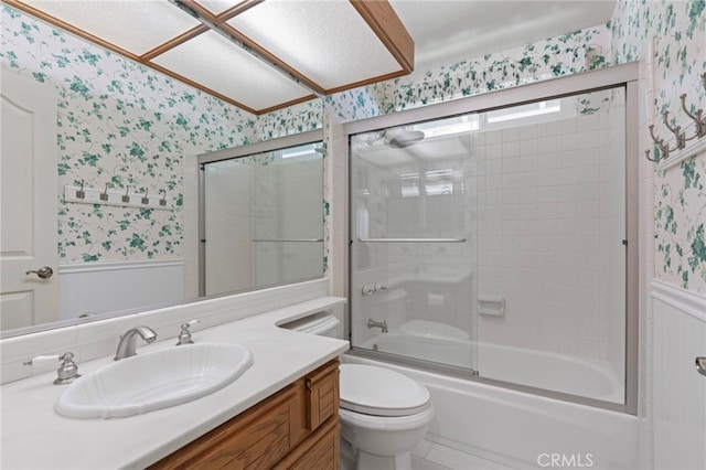 9 Edgestone, Irvine, CA 92606 - full bath featuring wallpapered walls, wainscoting, toilet, vanity, and enclosed tub / shower combo
