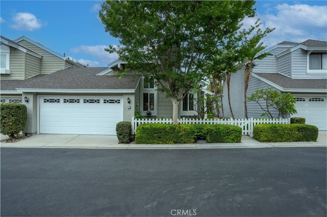 9 Edgestone, Irvine, CA 92606 - view of front of house with driveway, an attached garage, and roof with shingles