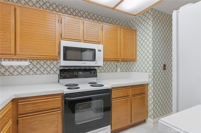 9 Edgestone, Irvine, CA 92606 - kitchen featuring white microwave, electric range, wallpapered walls, and light countertops