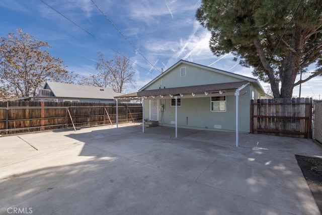 306 Belle Ave, Bakersfield, CA 93308 - rear view of property featuring stucco siding and a fenced backyard