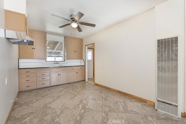 306 Belle Ave, Bakersfield, CA 93308 - kitchen with a heating unit, baseboards, ceiling fan, light brown cabinetry, and a sink