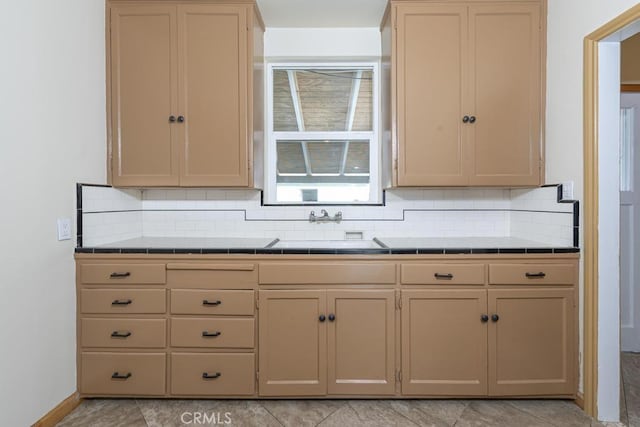 306 Belle Ave, Bakersfield, CA 93308 - kitchen featuring tile counters, a sink, and decorative backsplash