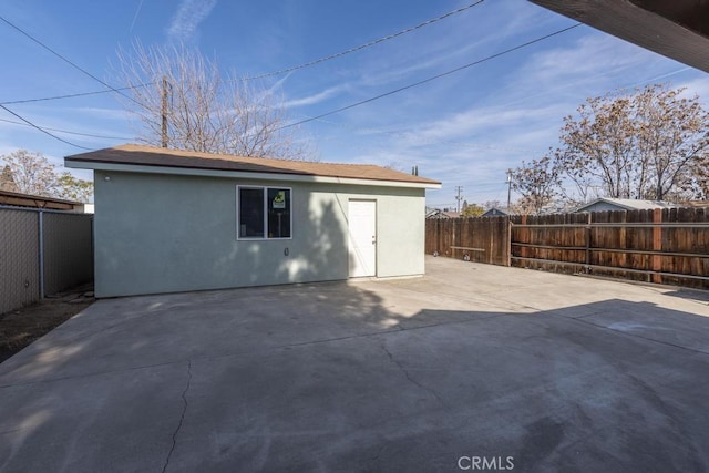 306 Belle Ave, Bakersfield, CA 93308 - back of property with stucco siding, a fenced backyard, and a patio area