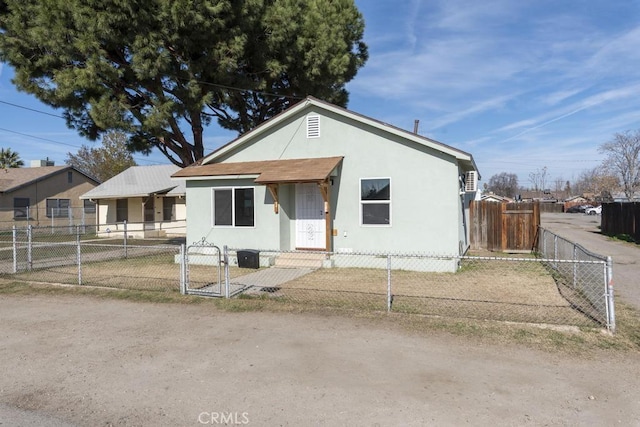 306 Belle Ave, Bakersfield, CA 93308 - bungalow-style home featuring a gate, stucco siding, and a fenced front yard