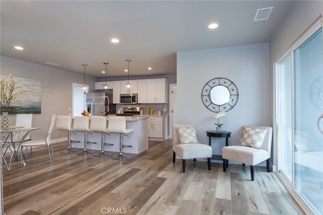 1923119229 Cantara St, Reseda, CA 91335 - kitchen featuring appliances with stainless steel finishes, light wood-style floors, white cabinetry, light countertops, and recessed lighting
