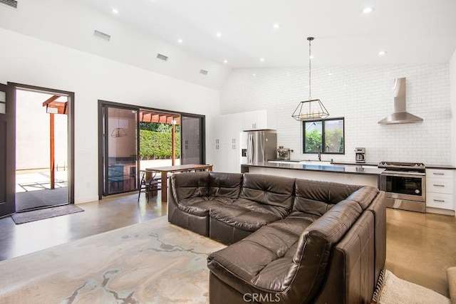 1923119229 Cantara St, Reseda, CA 91335 - living room featuring finished concrete flooring, plenty of natural light, high vaulted ceiling, and recessed lighting