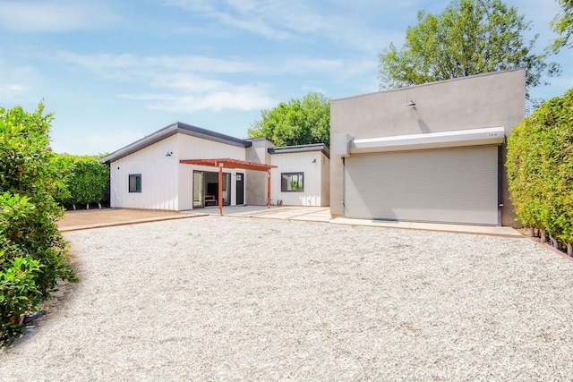 1923119229 Cantara St, Reseda, CA 91335 - view of front of property featuring a patio area, a garage, and gravel driveway