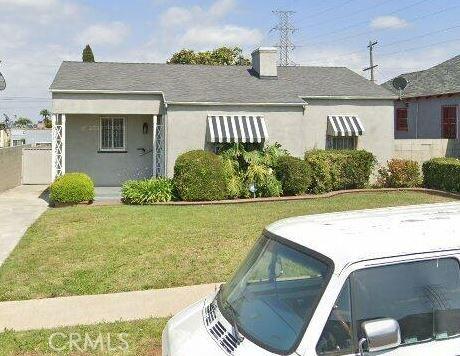 9646 La Salle Ave, Los Angeles, CA 90047 - bungalow-style home with a front yard, stucco siding, and a chimney